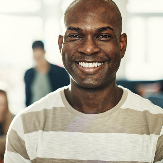 Man in a striped T shirt smiling