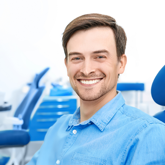 Smiling man sitting in the dental chair