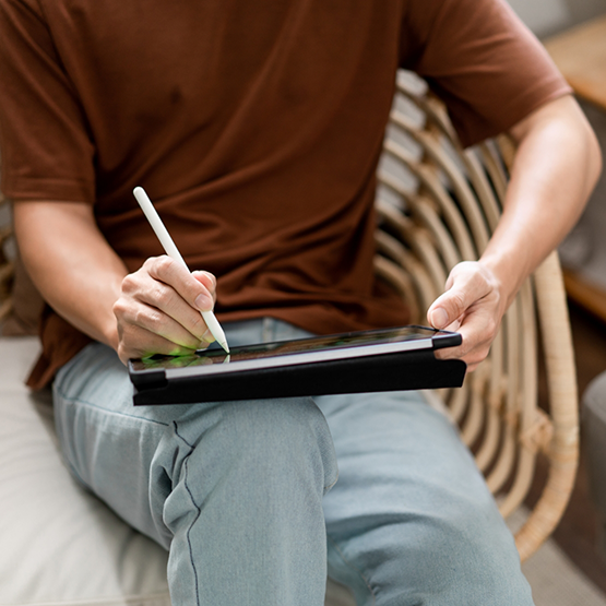 Person filling out forms on a tablet with a stylus