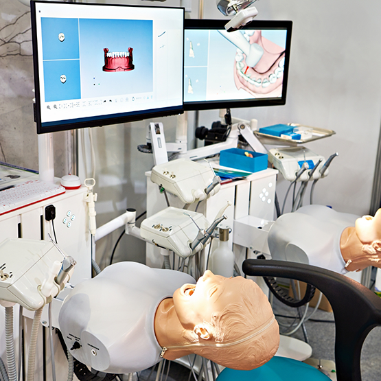 Row of practice treatment stations at a dental education facility