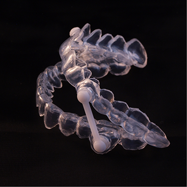 Clear oral appliance trays against a black background