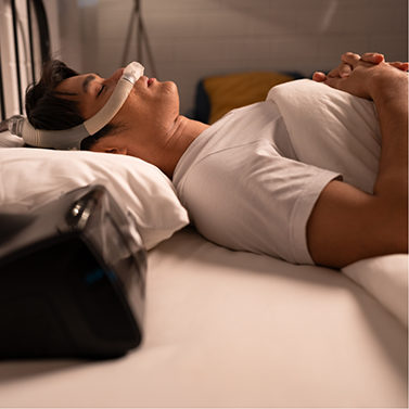 Man sleeping on his back with a CPAP