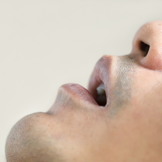 Close up side view of a man's mouth