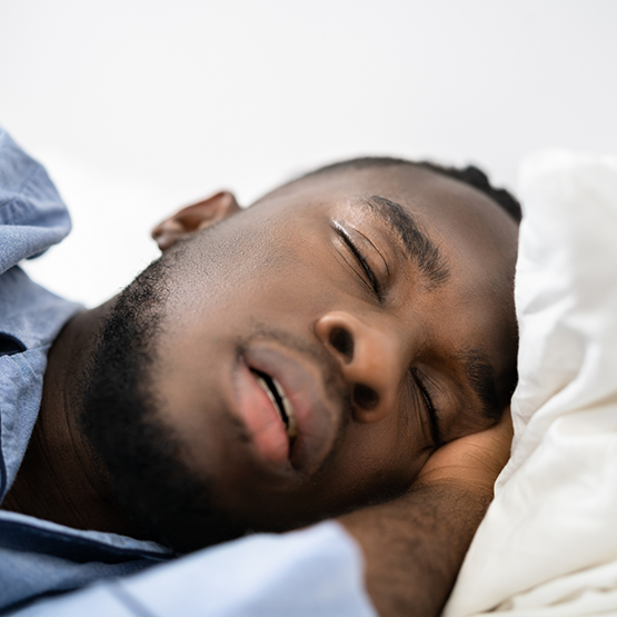 Man sleeping on his side with his mouth slightly open