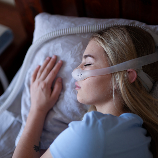 Sleeping woman wearing a CPAP mask