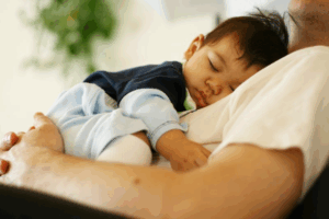 Parent and child snoozing in a recliner 